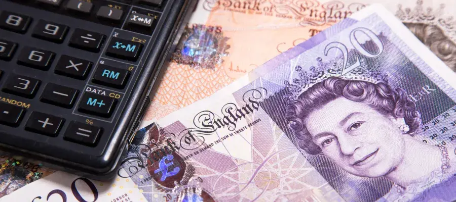 Calculator lying on top of £10 and £20 notes