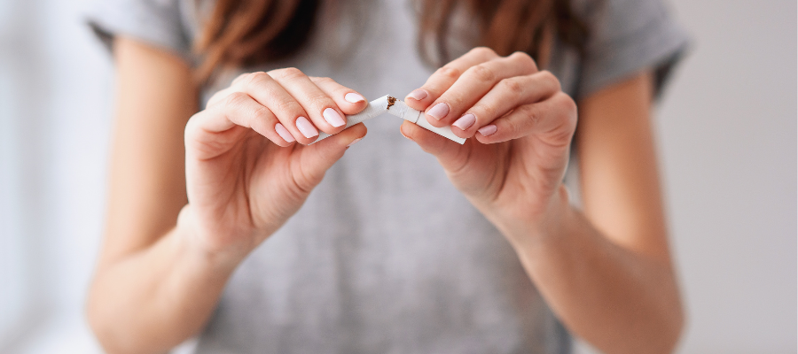 Close up of female snapping cigarette in half