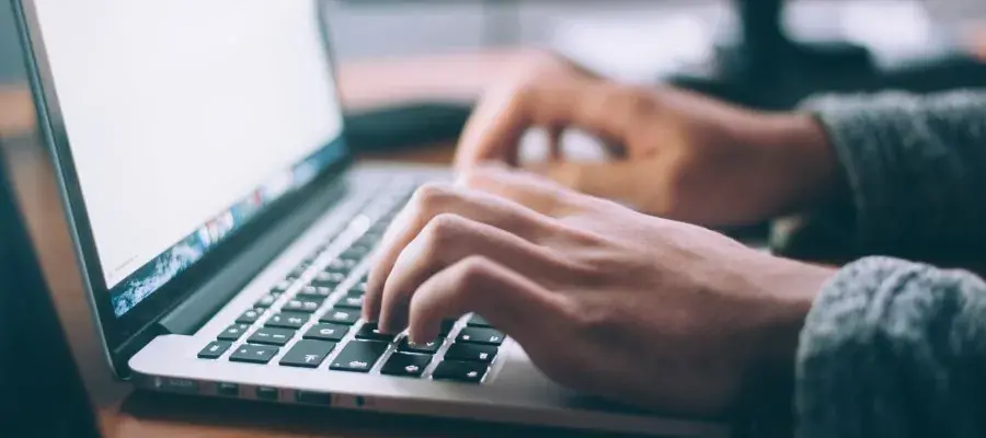 Typing on laptop