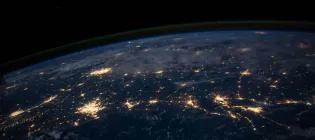 An image of the world from space showing the lights from space.
